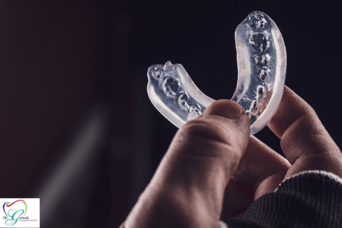 Athlete holding custom sports mouthguard in hand.